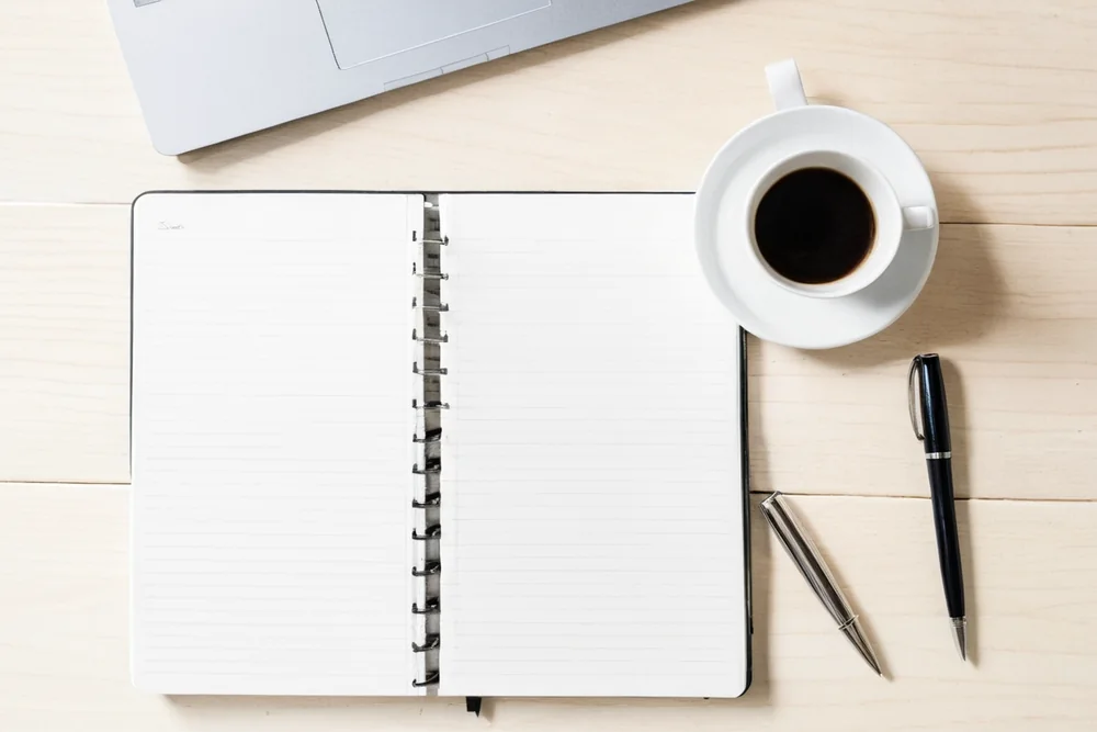An open notebook and pen ready for writing